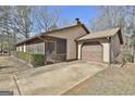 Ranch style home with a screened in porch, driveway, and partial view of the yard at 439 Elder St, Fairburn, GA 30213