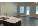 Bright living room with a chandelier and a view to the yard at 3405 Endurance Ct, South Fulton, GA 30349