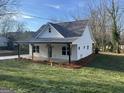 Exterior view of a charming home, featuring a covered front porch and landscaped surroundings at 5224 W Mountain St, Stone Mountain, GA 30083