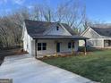 Attractive home with a welcoming front porch, a well-maintained lawn, and a paved driveway at 5224 W Mountain St, Stone Mountain, GA 30083