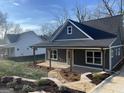 Charming gray home with a covered front porch, stone walkway, and beautifully landscaped yard at 5232 West Mountain Street, Stone Mountain, GA 30083