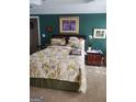 Comfortable bedroom with a floral bedspread, artwork, and a relaxing ambiance at 65 Coldwater Way, Covington, GA 30016