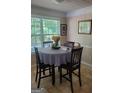 Cozy dining area featuring a round table, four chairs, and a window with natural light at 65 Coldwater Way, Covington, GA 30016