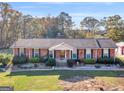 An elevated view of a brick single-story home with mature trees in the backyard and a well-kept lawn at 434 Lees Lake Rd, Fayetteville, GA 30214