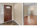 Inviting entryway featuring a decorative glass front door and a glimpse into the living room at 434 Lees Lake Rd, Fayetteville, GA 30214