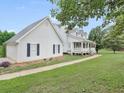 Exterior view of a home with white siding, attached garage, and green lawn at 2110 Mcgarity Rd, Mcdonough, GA 30252