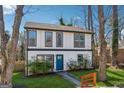 Charming two-story home with a welcoming blue door and fresh green lawn at 2405 Hillside Ave, Decatur, GA 30032