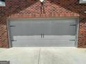Close-up of the two-car garage door on a brick home at 1687 Blue Heron Way, Hampton, GA 30228