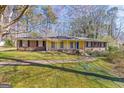 Charming single-story home featuring a blue front door, brick accents, and a well-maintained lawn at 437 Forrest Avenue Ave, Fayetteville, GA 30214
