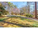 A home featuring a lush lawn and mature trees, providing a serene and private setting at 437 Forrest Avenue Ave, Fayetteville, GA 30214