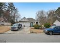 A beautiful, single story stucco home featuring a two car garage, blue front door, and landscaped front yard at 306 Preston Chase Dr, Peachtree City, GA 30269