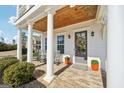 Inviting front porch with rocking chairs, brick floor, and a wooden ceiling adding warmth at 401 Hallman Pl, Peachtree City, GA 30269