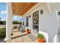 Inviting front porch with rocking chairs, brick floor, and a wooden ceiling adding warmth at 401 Hallman Pl, Peachtree City, GA 30269