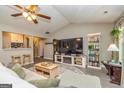 Comfortable living room features vaulted ceilings, large TV, and seamless flow to the kitchen at 11157 Ash Ct, Hampton, GA 30228