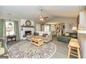 Inviting living room with a painted fireplace, neutral decor, and abundant natural light at 11157 Ash Ct, Hampton, GA 30228