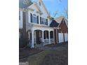 Lovely two-story home featuring a combination of brick and siding with an inviting, covered front porch at 5725 Lake Windsor Pkwy, Buford, GA 30518