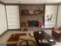 Cozy living room featuring a brick fireplace, built-in bookshelves, and a comfortable seating area at 392 Hwy 314, Fayetteville, GA 30214