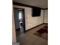 Living Room featuring stylish paneling, a mounted TV, and hardwood flooring at 392 Hwy 314, Fayetteville, GA 30214