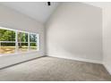 Spacious bedroom with a large window providing ample natural light and vaulted ceiling at 2291 Airline Road, Mcdonough, GA 30252