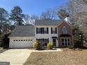 Charming two-story home with attached garage and well-maintained landscaping at 103 Vintage Trl, Mcdonough, GA 30253