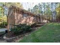 This ranch-style home boasts a beautiful brick exterior and meticulously maintained landscaping at 250 Devilla Trce, Fayetteville, GA 30214