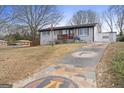 Exterior view of a charming home with a brick facade, a unique driveway, and a well-manicured lawn at 2827 Somerton Dr, Morrow, GA 30260