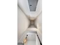 View looking up to the attic access point with decorative light fixture at 9135 Selborne Ln, Chattahoochee Hills, GA 30268