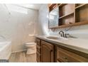 Bathroom featuring marble tile, a wood vanity with a sink, and a large mirror at 5365 Renault St, Cumming, GA 30041