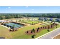 Aerial view shows the neighborhood amenities including tennis courts, dog park and volley ball at 600 Parnassus Rd, Locust Grove, GA 30248