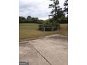 Fenced-in backyard with a concrete pad and a large grassy area at 1970 Pinecrest Dr, Morrow, GA 30260