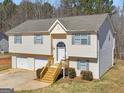 Inviting split-level home with a bright exterior, a covered entryway, and a spacious two-car garage at 195 Brighton Dr, Covington, GA 30016