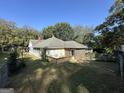View of the rear of the home, featuring a wooden deck and screened-in porch at 3 Elm St, Porterdale, GA 30014
