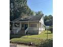 Charming bungalow featuring a cozy front porch and fenced yard at 3 Elm St, Porterdale, GA 30014