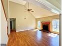 Bright living room with high ceilings, a warm fireplace, and gleaming hardwood floors offers inviting space at 1029 Hines Rd, Moreland, GA 30259
