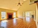 Spacious living room features a cozy fireplace, hardwood floors, and abundant natural light from large windows at 1029 Hines Rd, Moreland, GA 30259