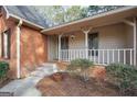 Inviting covered porch with white railings and brick accents at 105 Jasper Dr, Stockbridge, GA 30281