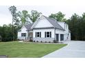 Side view of a stylish two-story house featuring an attached garage and a well-kept lawn at 349 Lowbrooke Ct # 19, Fairburn, GA 30213