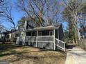 Charming gray home featuring a covered front porch with white railings and steps at 1457 Richland Sw Rd, Atlanta, GA 30310
