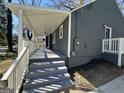 Inviting covered porch with gray painted steps and white railings, offering a relaxing outdoor space at 1457 Richland Sw Rd, Atlanta, GA 30310