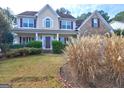 Well-maintained two-story home with manicured lawn and mature landscaping in a suburban neighborhood at 976 Buckhorn Bnd, Locust Grove, GA 30248