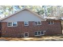 Rear exterior of brick home with many windows providing plenty of natural light at 863 New Hope Dr, Hampton, GA 30228