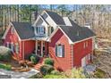 Stunning two-story red brick home featuring a covered front porch and a well-manicured yard at 417 Harper Rd, Mcdonough, GA 30252