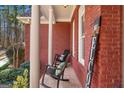 Inviting front porch with rocking chairs, brick floors, and a 'Welcome' sign for a cozy feel at 417 Harper Rd, Mcdonough, GA 30252