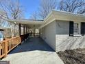 Covered parking and attached walkway lead to the charming exterior with address 791 displayed at 791 Gertrude Nw Pl, Atlanta, GA 30318