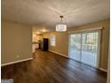 Open dining area with hardwood floors, sliding doors, and modern lighting at 2205 Chestnut Hill Cir, Decatur, GA 30032