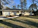 A single Gathering home featuring a well manicured lawn with mature trees at 2205 Chestnut Hill Cir, Decatur, GA 30032