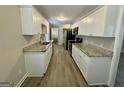 Bright kitchen featuring granite countertops, white cabinets, and stainless steel appliances at 2690 Rollingwood Se Ln, Atlanta, GA 30316