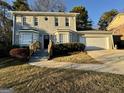 Charming two-story home with a well-maintained front yard and attached two-car garage at 6380 Phillips Pl, Lithonia, GA 30058