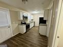 Newly renovated kitchen with granite countertops, stainless steel appliances and modern cabinetry at 6380 Phillips Pl, Lithonia, GA 30058