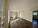 Bright living room featuring new wood floors, neutral paint, and plenty of natural light at 1965 Rollingwood Se Dr, Atlanta, GA 30316